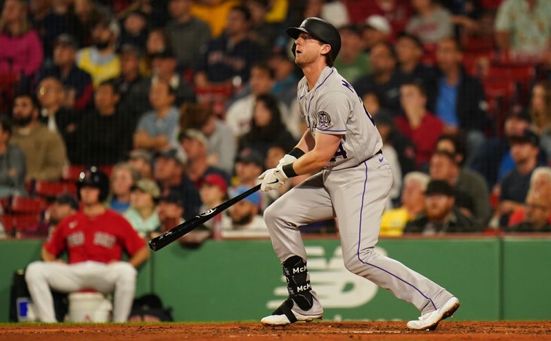 Jun 14, 2023; Boston, Massachusetts, USA; Colorado Rockies third baseman Ryan McMahon (24) hits a double to left field to drive in a run against the Boston Red Sox in the sixth inning at Fenway Park. Mandatory Credit: David Butler II-USA TODAY Sports