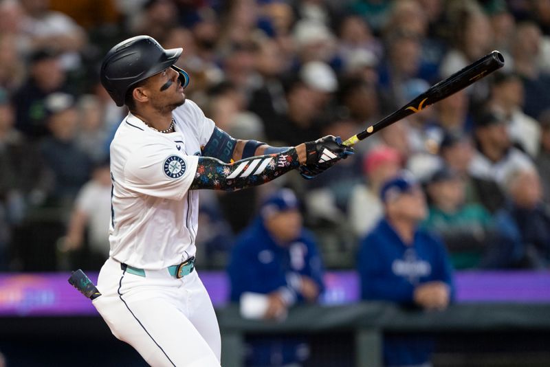 Jun 15, 2024; Seattle, Washington, USA; Seattle Mariners centerfielder Julio Rodriguez (44) hits a two-run home run during the third inning against the Texas Rangers at T-Mobile Park. Mandatory Credit: Stephen Brashear-USA TODAY Sports