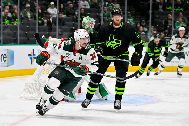 Jan 10, 2024; Dallas, Texas, USA; Minnesota Wild right wing Mats Zuccarello (36) and Dallas Stars defenseman Jani Hakanpaa (2) chase the puck during the first period at the American Airlines Center. Mandatory Credit: Jerome Miron-USA TODAY Sports