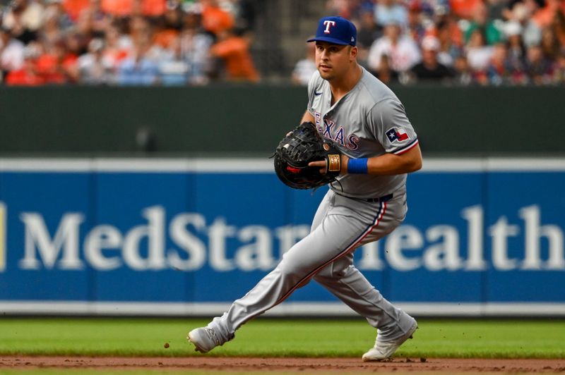 Jun 29, 2024; Baltimore, Maryland, USA;  Texas Rangers first baseman Nathaniel Lowe (30) field a first inning ground ball against the Texas Rangers at Oriole Park at Camden Yards. Mandatory Credit: Tommy Gilligan-USA TODAY Sports