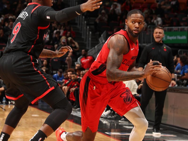 MIAMI, FL - DECEMBER 12:  Haywood Highsmith #24 of the Miami Heat dribbles the ball during the game against the Toronto Raptors on December 12, 2024 at Kaseya Center in Miami, Florida. NOTE TO USER: User expressly acknowledges and agrees that, by downloading and or using this Photograph, user is consenting to the terms and conditions of the Getty Images License Agreement. Mandatory Copyright Notice: Copyright 2024 NBAE (Photo by Issac Baldizon/NBAE via Getty Images)