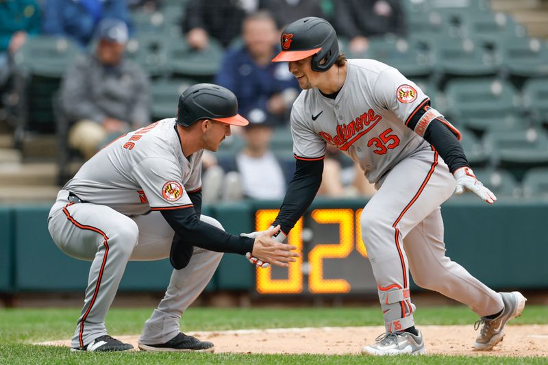 May 26, 2024; Chicago, Illinois, USA; Baltimore Orioles catcher Adley Rutschman (35) celebrates with third baseman Jordan Westburg (11) after hitting a two-run home run against the Chicago White Sox during the sixth inning at Guaranteed Rate Field. Mandatory Credit: Kamil Krzaczynski-USA TODAY Sports