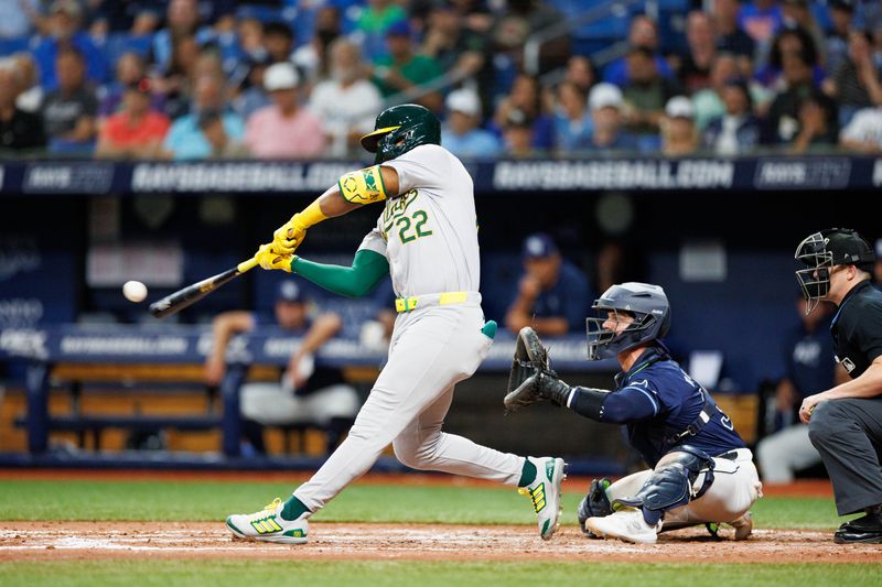 May 28, 2024; St. Petersburg, Florida, USA;  Oakland Athletics outfielder Miguel Andujar (22) hits a three run home run against the Tampa Bay Rays in the sixth inning  at Tropicana Field. Mandatory Credit: Nathan Ray Seebeck-USA TODAY Sports