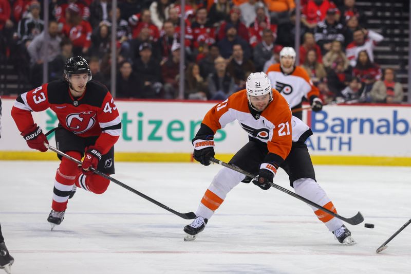 Jan 18, 2025; Newark, New Jersey, USA; Philadelphia Flyers center Scott Laughton (21) plays the puck while being defended by New Jersey Devils defenseman Luke Hughes (43) during the first period at Prudential Center. Mandatory Credit: Ed Mulholland-Imagn Images