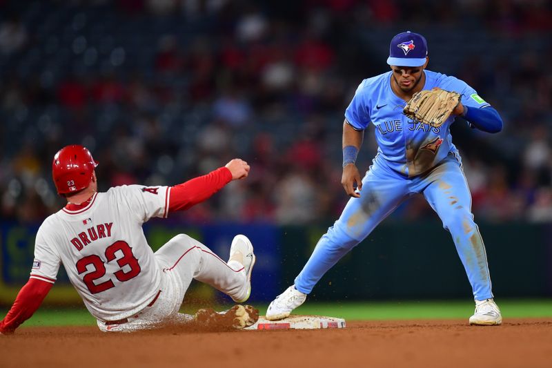 Aug 13, 2024; Anaheim, California, USA; Los Angeles Angels second baseman Brandon Drury (23) is out at second by Toronto Blue Jays shortstop Leo Jimenez (49) during the fifth inning at Angel Stadium. Mandatory Credit: Gary A. Vasquez-USA TODAY Sports