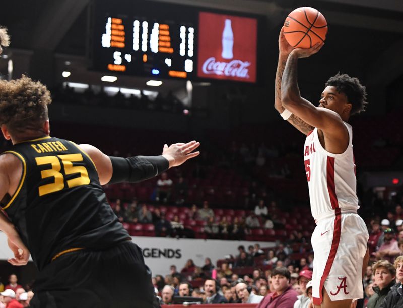 Jan 16, 2024; Tuscaloosa, Alabama, USA; Alabama guard Aaron Estrada takes a three point shot with Missouri forward Noah Carter (35) defending in their game at Coleman Coliseum. Mandatory Credit: Gary Cosby Jr.-USA TODAY Sports