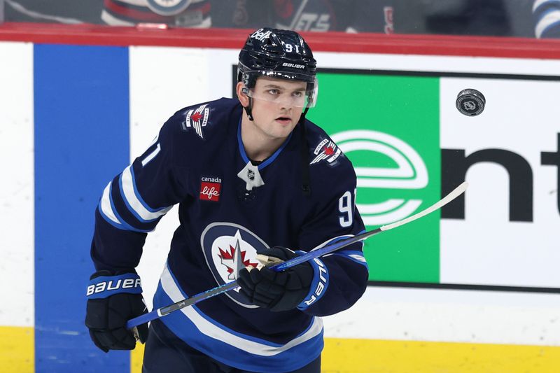 Jan 7, 2025; Winnipeg, Manitoba, CAN; Winnipeg Jets center Cole Perfetti (91) puck juggles before a game against the Nashville Predators at Canada Life Centre. Mandatory Credit: James Carey Lauder-Imagn Images