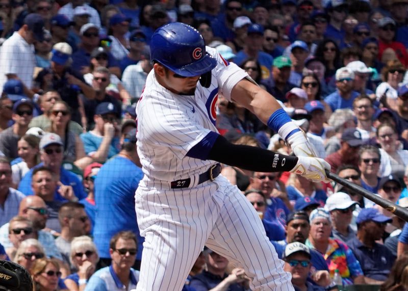 Aug 19, 2023; Chicago, Illinois, USA; Chicago Cubs right fielder Seiya Suzuki (27) hits a sacrifice fly against the Kansas City Royals during the second inning at Wrigley Field. Mandatory Credit: David Banks-USA TODAY Sports