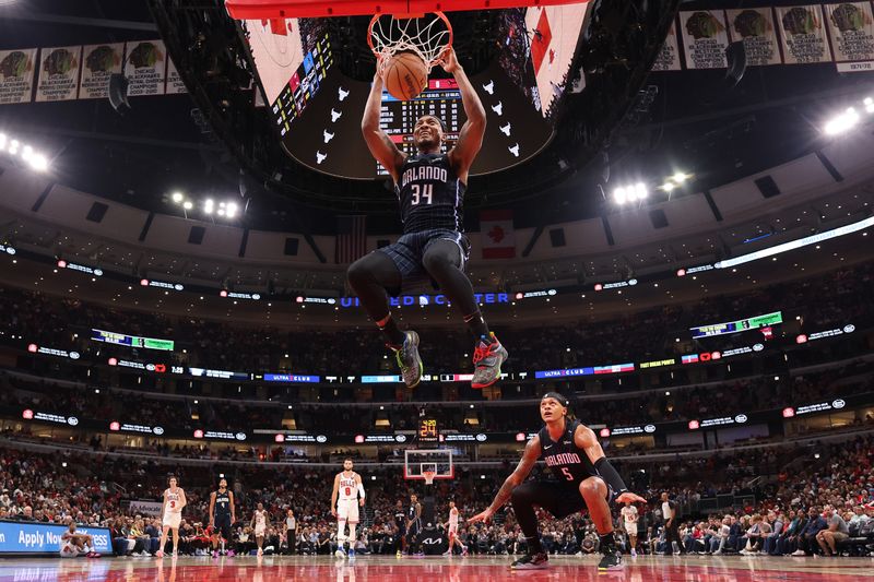 CHICAGO, ILLINOIS - OCTOBER 30: Wendell Carter Jr. #34 of the Orlando Magic dunks the ball as Paolo Banchero #5 celebrates against the Chicago Bulls during the first half at the United Center on October 30, 2024 in Chicago, Illinois. NOTE TO USER: User expressly acknowledges and agrees that, by downloading and or using this photograph, User is consenting to the terms and conditions of the Getty Images License Agreement.  (Photo by Michael Reaves/Getty Images)