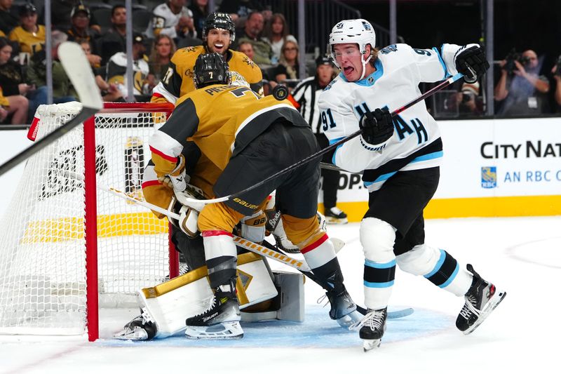 Sep 27, 2024; Las Vegas, Nevada, USA; Utah Hockey Club forward Josh Doan (91) looks to control the puck behind Vegas Golden Knights defenseman Alex Pietrangelo (7) during the first period at T-Mobile Arena. Mandatory Credit: Stephen R. Sylvanie-Imagn Images