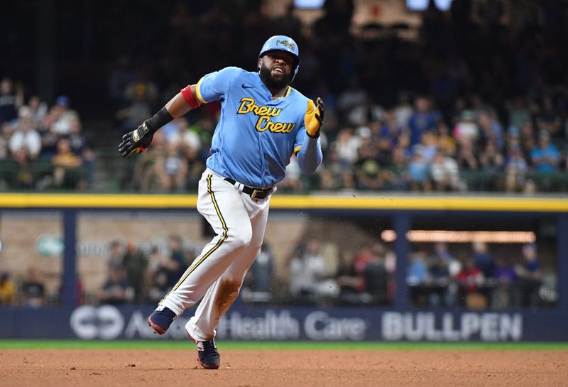 Aug 25, 2023; Milwaukee, Wisconsin, USA; Milwaukee Brewers first baseman Carlos Santana (41) rounds second bases and reaches third base against the San Diego Padres in the seventh inning at American Family Field. Mandatory Credit: Michael McLoone-USA TODAY Sports