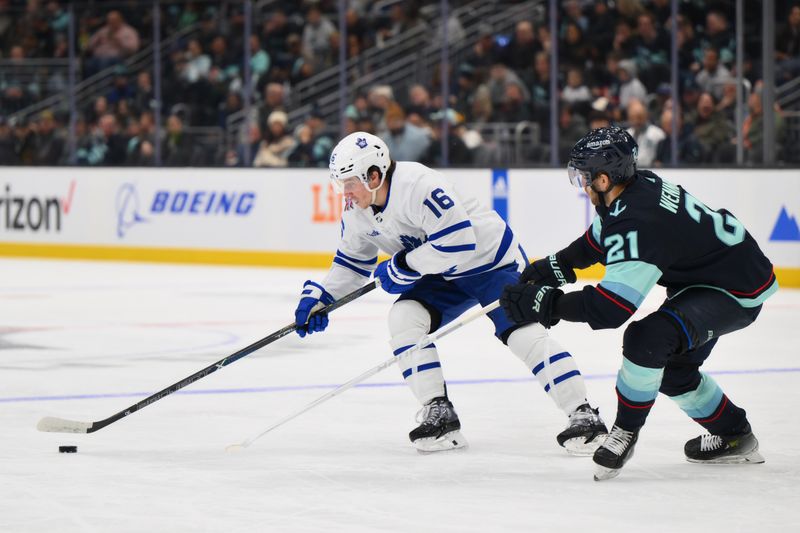 Jan 21, 2024; Seattle, Washington, USA; Toronto Maple Leafs right wing Mitchell Marner (16) advances the puck while defended by Seattle Kraken center Alex Wennberg (21) during the third period at Climate Pledge Arena. Mandatory Credit: Steven Bisig-USA TODAY Sports