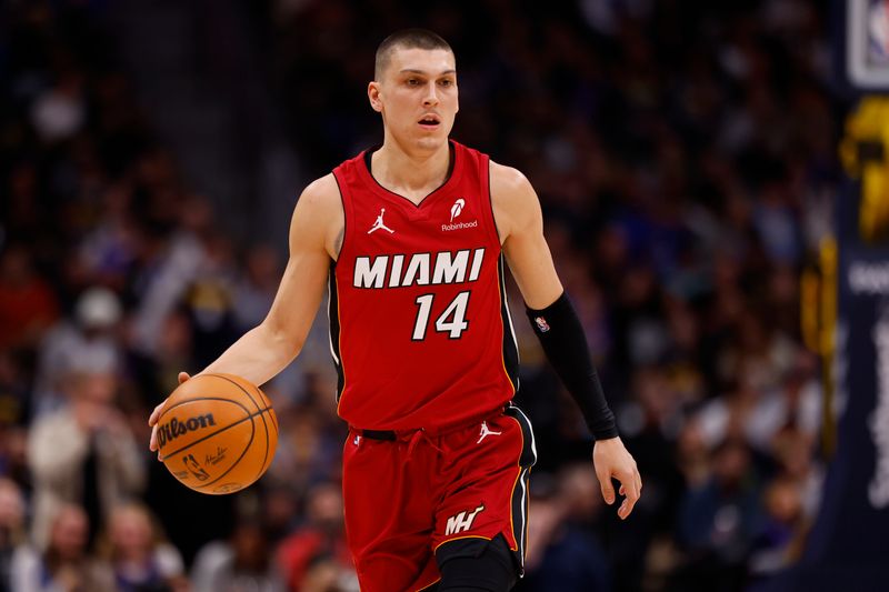 DENVER, COLORADO - NOVEMBER 8: Tyler Herro #14 of the Miami Heat handles the ball against the Denver Nuggets during the first quarter at Ball Arena on November 8, 2024 in Denver, Colorado. NOTE TO USER: User expressly acknowledges and agrees that, by downloading and or using this photograph, User is consenting to the terms and conditions of the Getty Images License Agreement. (Photo by C. Morgan Engel/Getty Images)