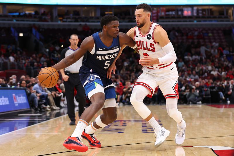 CHICAGO, ILLINOIS - OCTOBER 16: Anthony Edwards #5 of the Minnesota Timberwolves dribbles against Zach LaVine #8 of the Chicago Bulls during the second half of a preseason game at the United Center on October 16, 2024 in Chicago, Illinois. NOTE TO USER: User expressly acknowledges and agrees that, by downloading and or using this photograph, User is consenting to the terms and conditions of the Getty Images License Agreement.  (Photo by Michael Reaves/Getty Images)