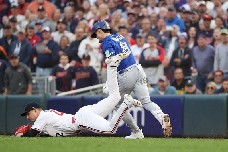 Oct 4, 2023; Minneapolis, Minnesota, USA; Minnesota Twins relief pitcher Griffin Jax (22) tags out Toronto Blue Jays second baseman Cavan Biggio (8) in the eighth inning  during game two of the Wildcard series for the 2023 MLB playoffs at Target Field. Mandatory Credit: Jesse Johnson-USA TODAY Sports