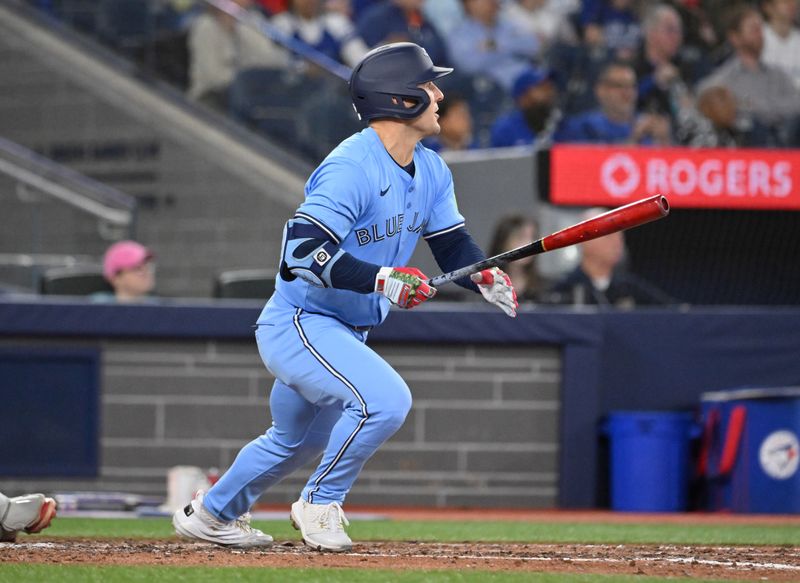 May 1, 2025; Toronto, Ontario, CAN;  Toronto Blue Jays center fielder Daulton Varsho (5) hits a solo home run against the Boston Red Sox in the seventh inning at Rogers Centre. Mandatory Credit: Dan Hamilton-Imagn Images
