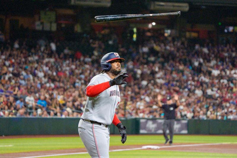 May 31, 2025; Phoenix, Arizona, USA;  Washington Nationals infielder Josh Bell (19) reacts and throws his bat after drawing the walk during his first at bat in the first inning against the Arizona Diamondbacks at Chase Field. Mandatory Credit: Allan Henry-Imagn Images