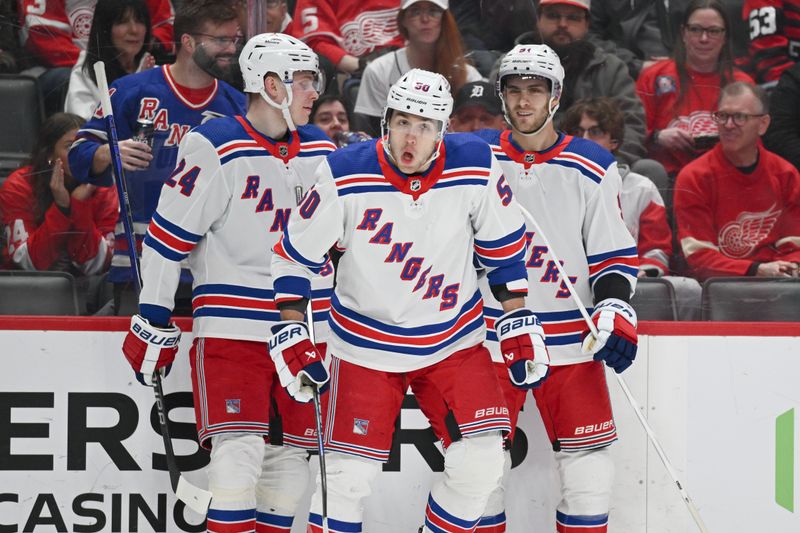 Apr 5, 2024; Detroit, Michigan, USA; New York Rangers left wing Will Cuylle (50) celebrates his with right wing Kaapo Kakko (24) and center Alex Wennberg (91) during the first period against the Detroit Red Wings at Little Caesars Arena. Mandatory Credit: Tim Fuller-USA TODAY Sports