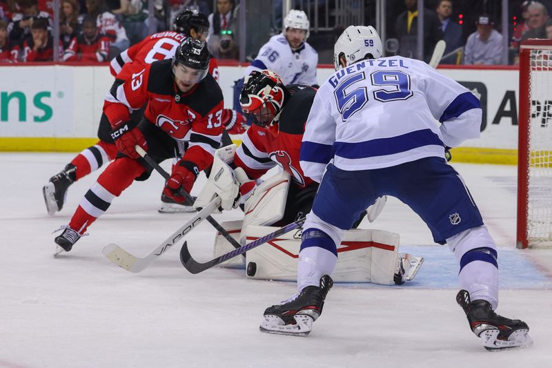 Oct 22, 2024; Newark, New Jersey, USA; New Jersey Devils goaltender Jake Allen (34) makes a save against the Tampa Bay Lightning during the first period at Prudential Center. Mandatory Credit: Ed Mulholland-Imagn Images