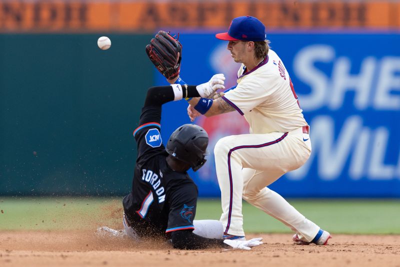 Jun 29, 2024; Philadelphia, Pennsylvania, USA; Philadelphia Phillies second base Bryson Stott (5) tags out Miami Marlins outfielder Nick Gordon (1) during the ninth inning at Citizens Bank Park. Mandatory Credit: Bill Streicher-USA TODAY Sports