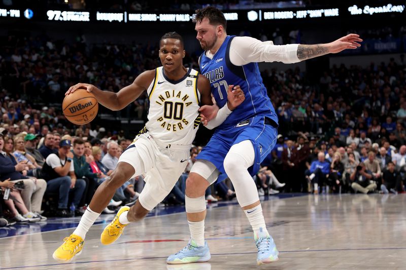 DALLAS, TEXAS - MARCH 05: Bennedict Mathurin #00 of the Indiana Pacers dribbles the ball to the basket against Luka Doncic #77 of the Dallas Mavericks in the second half at American Airlines Center on March 05, 2024 in Dallas, Texas. NOTE TO USER: User expressly acknowledges and agrees that, by downloading and or using this photograph, User is consenting to the terms and conditions of the Getty Images License Agreement. (Photo by Tim Heitman/Getty Images)