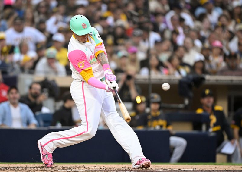 May 30, 2025; San Diego, California, USA; San Diego Padres third baseman Manny Machado (13) hits a double during the fourth inning against the Pittsburgh Pirates at Petco Park. Mandatory Credit: Denis Poroy-Imagn Images