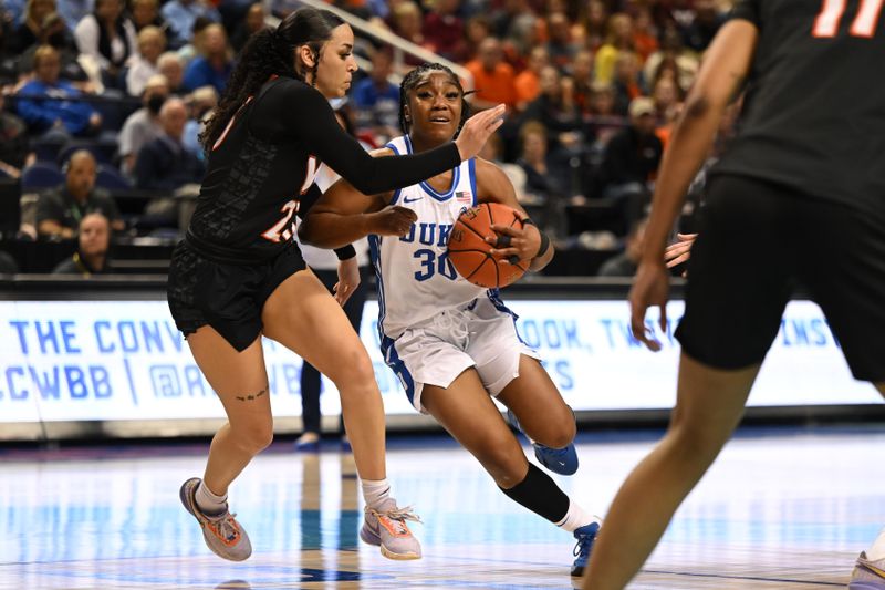 Mar 4, 2023; Greensboro, NC, USA; Duke Blue Devils guard Shayeann Day-Wilson (30) drives against Virginia Tech Hokies guard Kayana Traylor (23) during the second half at Greensboro Coliseum. Mandatory Credit: William Howard-USA TODAY Sports