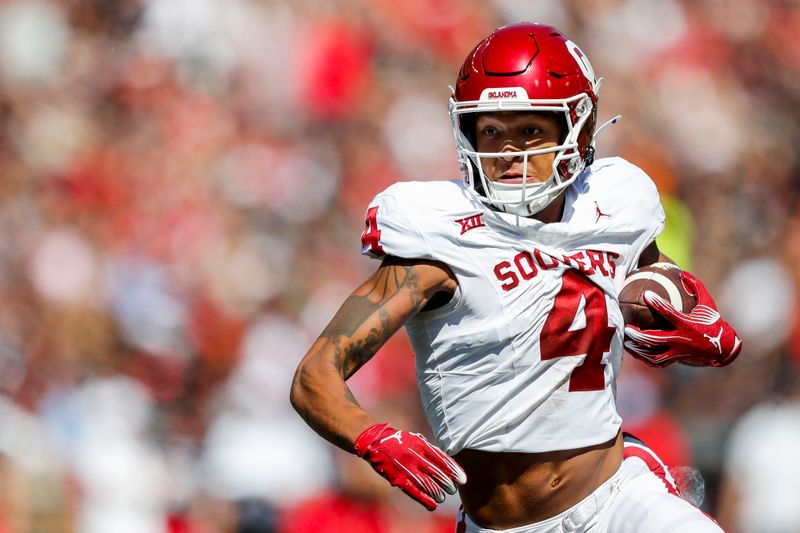 Sep 23, 2023; Cincinnati, Ohio, USA; Oklahoma Sooners wide receiver Nic Anderson (4) runs the ball in for a touchdown against the Cincinnati Bearcats in the first half at Nippert Stadium. Mandatory Credit: Katie Stratman-USA TODAY Sports