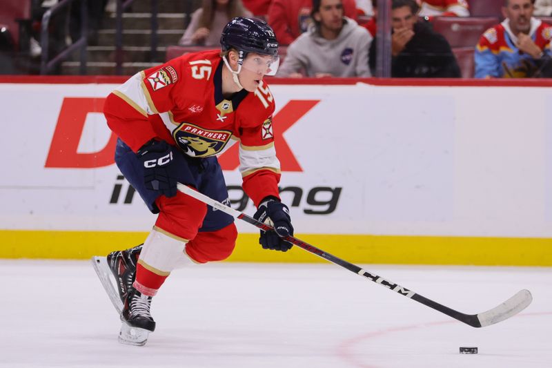 Apr 9, 2024; Sunrise, Florida, USA; Florida Panthers center Anton Lundell (15) moves the puck against the Ottawa Senators during the first period at Amerant Bank Arena. Mandatory Credit: Sam Navarro-USA TODAY Sports