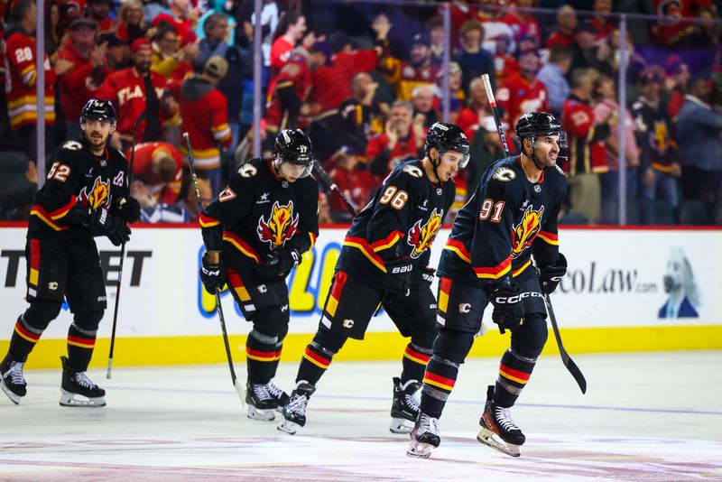 Oct 26, 2024; Calgary, Alberta, CAN; Calgary Flames center Nazem Kadri (91) celebrates his goal with teammates against the Winnipeg Jets during the third period at Scotiabank Saddledome. Mandatory Credit: Sergei Belski-Imagn Images