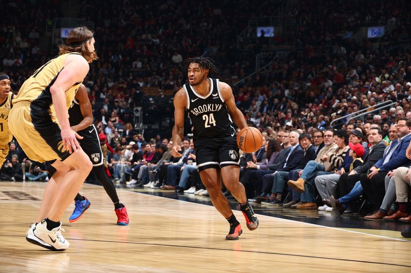 TORONTO, CANADA - FEBRUARY 22: Cam Thomas #24 of the Brooklyn Nets handles the ball against Kelly Olynyk #41 of the Toronto Raptors during the game on February 22, 2024 at the Scotiabank Arena in Toronto, Ontario, Canada.  NOTE TO USER: User expressly acknowledges and agrees that, by downloading and or using this Photograph, user is consenting to the terms and conditions of the Getty Images License Agreement.  Mandatory Copyright Notice: Copyright 2024 NBAE (Photo by Vaughn Ridley/NBAE via Getty Images)