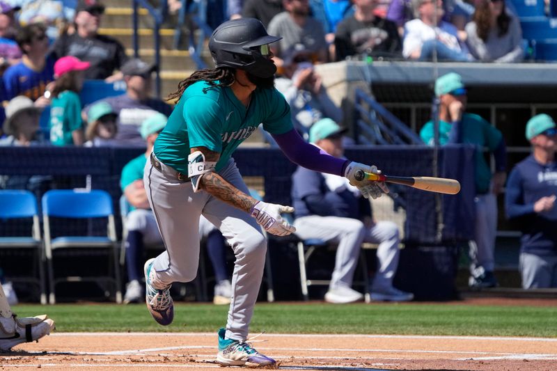 Mar 9, 2024; Phoenix, Arizona, USA; Seattle Mariners shortstop PJ Crawford (3) hits a double against the Milwaukee Brewers in the first inning at American Family Fields of Phoenix. Mandatory Credit: Rick Scuteri-USA TODAY Sports