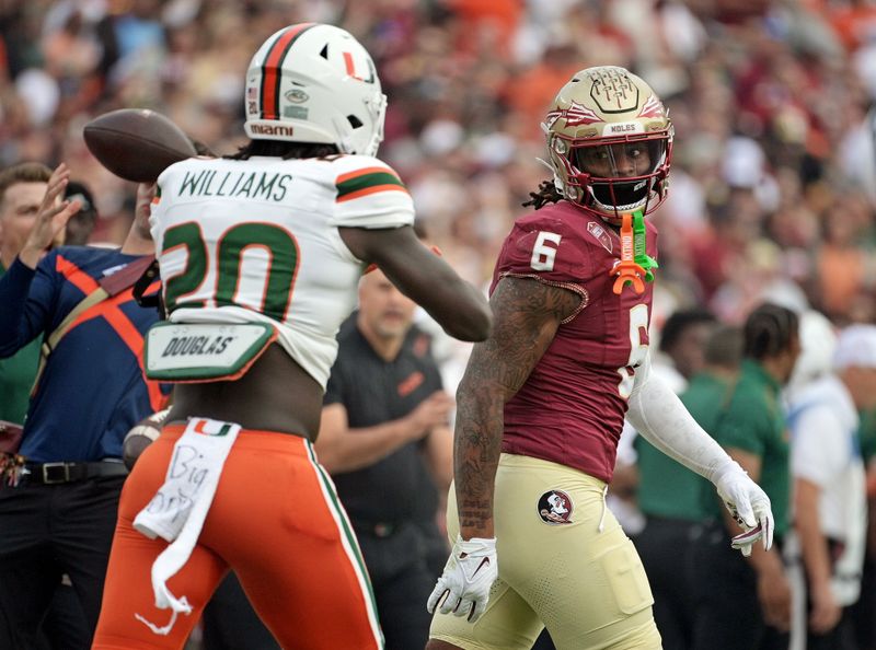 Nov 11, 2023; Tallahassee, Florida, USA; Florida State Seminoles tight end Jaheim Bell (6) looks back at Miami Hurricanes defensive back James Williams (20) during the first quarter at Doak S. Campbell Stadium. Mandatory Credit: Melina Myers-USA TODAY Sports