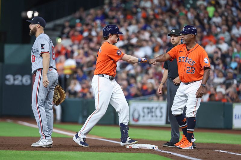 May 31, 2024; Houston, Texas, USA; Houston Astros center fielder Jake Meyers (6) celebrates with first base coach Dave Clark (23) after hitting a single during the second inning against the Minnesota Twins at Minute Maid Park. Mandatory Credit: Troy Taormina-USA TODAY Sports