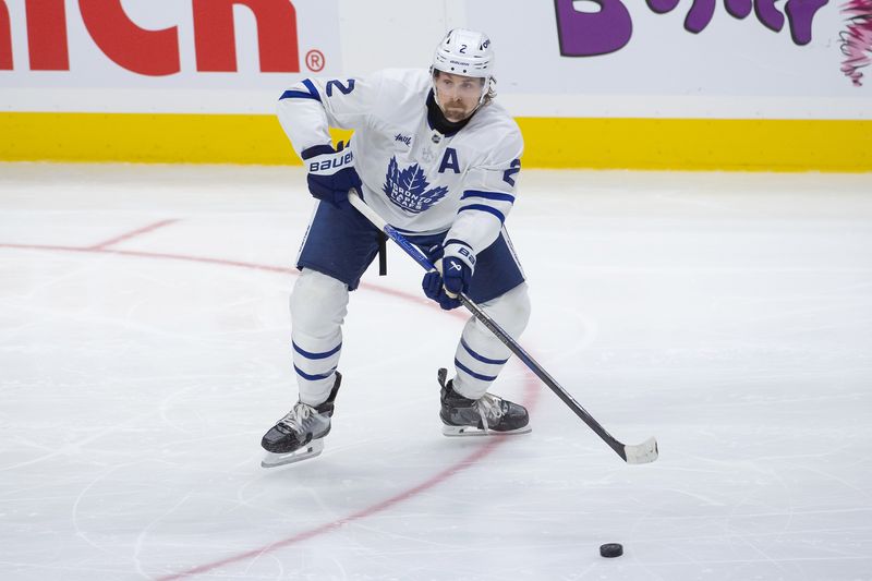 Sep 24, 2024; Ottawa, Ontario, CAN; Toronto Maple Leafs defenseman Simon Benoit (2) shoots the puck in the first period against the Ottawa Senators at the Canadian Tire Centre. Mandatory Credit: Marc DesRosiers-Imagn Images