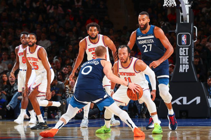 NEW YORK, NY - OCTOBER 13: Donte DiVincenzo #0 of the Minnesota Timberwolves is defended by Jalen Brunson #11 of the New York Knicks on October 13, 2024 at Madison Square Garden in New York City, New York.  NOTE TO USER: User expressly acknowledges and agrees that, by downloading and or using this photograph, User is consenting to the terms and conditions of the Getty Images License Agreement. Mandatory Copyright Notice: Copyright 2024 NBAE  (Photo by David L. Nemec/NBAE via Getty Images)