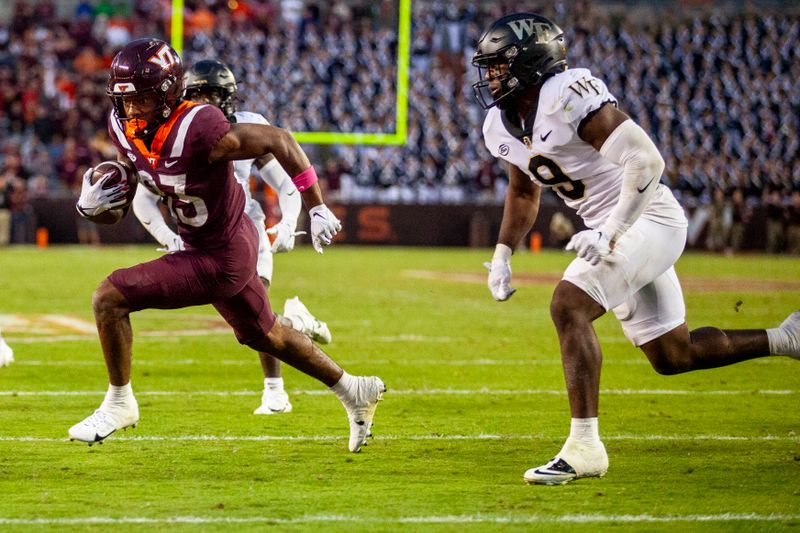 Oct 14, 2023; Blacksburg, Virginia, USA; Virginia Tech Hokies wide receiver Jaylin Lane (83) scores a touchdown against Wake Forest Demon Deacons defensive back Chelen Garnes (9) during the fourth quarter at Lane Stadium. Mandatory Credit: Peter Casey-USA TODAY Sports