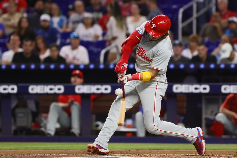 Sep 5, 2024; Miami, Florida, USA; Philadelphia Phillies second baseman Bryson Stott (5) hits an RBI single against the Miami Marlins during the first inning at loanDepot Park. Mandatory Credit: Sam Navarro-Imagn Images