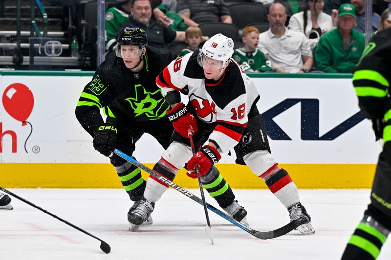 Mar 14, 2024; Dallas, Texas, USA; Dallas Stars defenseman Esa Lindell (23) and New Jersey Devils left wing Ondrej Palat (18) chase the puck during the third period at the American Airlines Center. Mandatory Credit: Jerome Miron-USA TODAY Sports