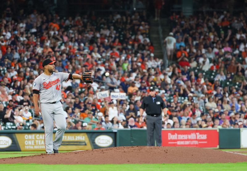 Jun 23, 2024; Houston, Texas, USA; Baltimore Orioles starting pitcher Albert Suarez (49) reacts to Houston Astros first baseman Mauricio Dubon (14) (not pictured) RBI single in the first inning at Minute Maid Park. Mandatory Credit: Thomas Shea-USA TODAY Sports