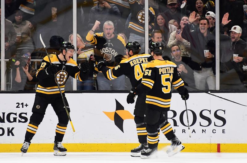 Nov 7, 2024; Boston, Massachusetts, USA;  Boston Bruins center Charlie Coyle (13) reacts after a goal by left wing Cole Koepke (45) during the second period against the Calgary Flames at TD Garden. Mandatory Credit: Bob DeChiara-Imagn Images