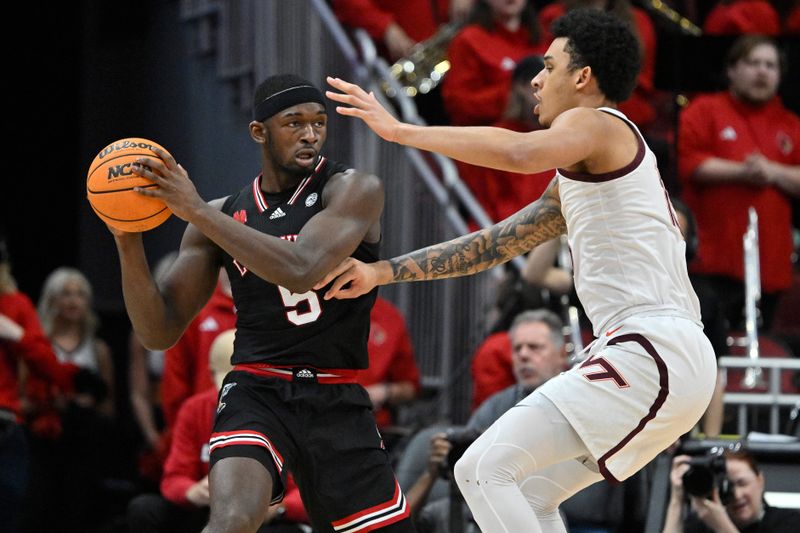 Mar 5, 2024; Louisville, Kentucky, USA; Louisville Cardinals forward Brandon Huntley-Hatfield (5) looks to pass under the pressure of Virginia Tech Hokies center Lynn Kidd (15) during the first half at KFC Yum! Center. Mandatory Credit: Jamie Rhodes-USA TODAY Sports