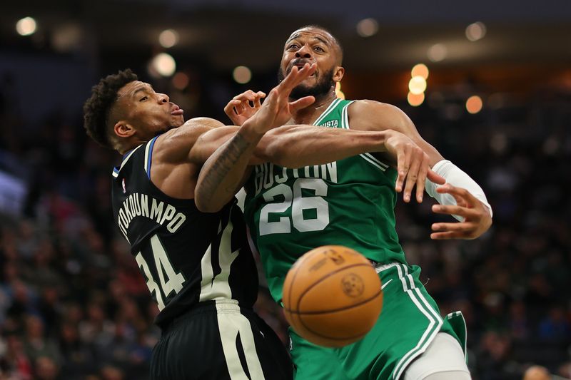 MILWAUKEE, WISCONSIN - APRIL 09: Giannis Antetokounmpo #34 of the Milwaukee Bucks knocks the ball away from Xavier Tillman #26 of the Boston Celtics during the second half of a game at Fiserv Forum on April 09, 2024 in Milwaukee, Wisconsin. NOTE TO USER: User expressly acknowledges and agrees that, by downloading and or using this photograph, User is consenting to the terms and conditions of the Getty Images License Agreement. (Photo by Stacy Revere/Getty Images)