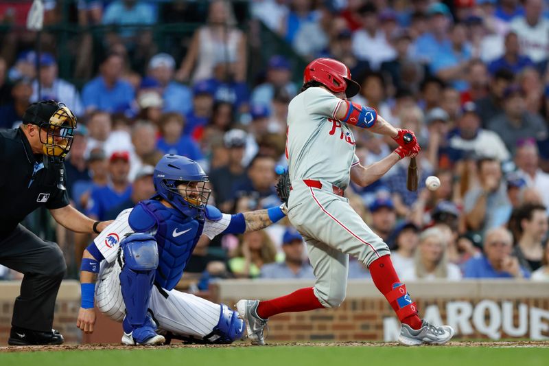 Jul 2, 2024; Chicago, Illinois, USA; Philadelphia Phillies catcher Garrett Stubbs (21) hits a two-run double against the Chicago Cubs during the second inning at Wrigley Field. Mandatory Credit: Kamil Krzaczynski-USA TODAY Sports