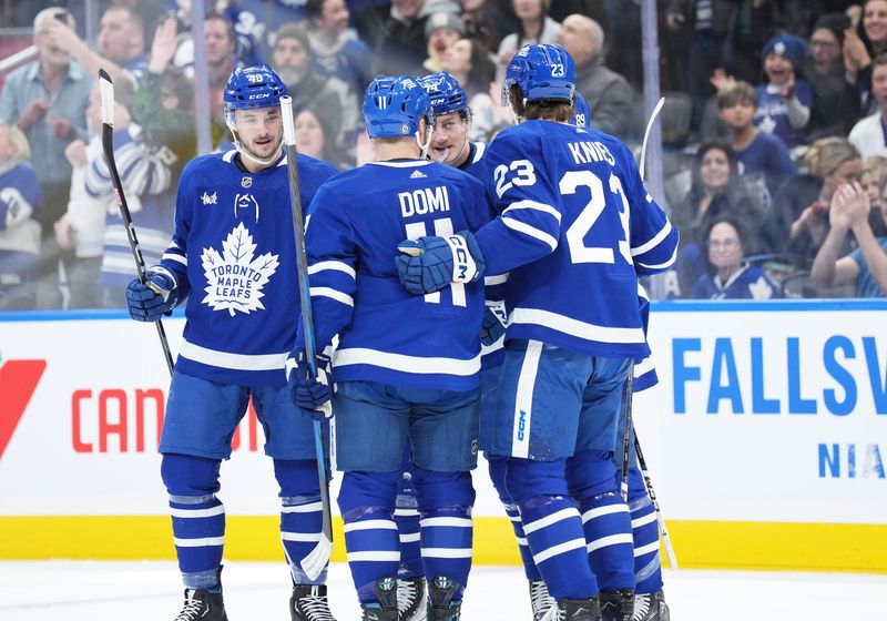 Feb 17, 2024; Toronto, Ontario, CAN; Toronto Maple Leafs center Bobby McMann (74) scores a goal and celebrates with left wing Matthew Knies (23) against the Anaheim Ducks during the first period at Scotiabank Arena. Mandatory Credit: Nick Turchiaro-USA TODAY Sports