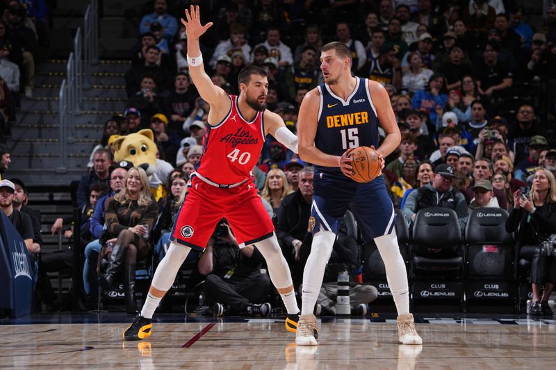 DENVER, CO - DECEMBER 13: Nikola Jokic #15 of the Denver Nuggets handles the ball during the game against the LA Clippers on December 13, 2024 at Ball Arena in Denver, Colorado. NOTE TO USER: User expressly acknowledges and agrees that, by downloading and/or using this Photograph, user is consenting to the terms and conditions of the Getty Images License Agreement. Mandatory Copyright Notice: Copyright 2024 NBAE (Photo by Garrett Ellwood/NBAE via Getty Images)