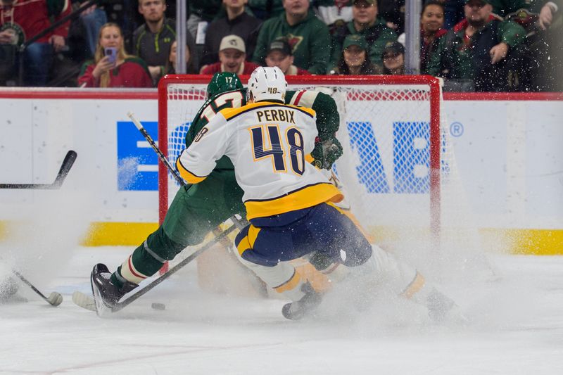 Dec 23, 2025; Saint Paul, Minnesota, USA; Minnesota Wild left wing Marcus Foligno (17) sprays Nashville Predators goaltender Juuse Saros (74) as he shoots, defended by defenseman Nick Perbix (48) in the first period at Grand Casino Arena. Mandatory Credit: Matt Blewett-Imagn Images