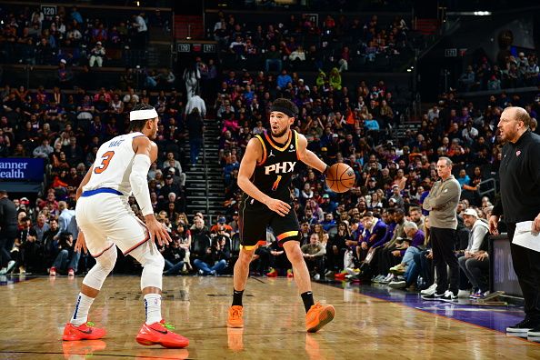 PHOENIX, AZ - DECEMBER 15: Josh Hart #3 of the New York Knicks plays defense against Devin Booker #1 of the Phoenix Suns during the game on December 15, 2023 at Footprint Center in Phoenix, Arizona. NOTE TO USER: User expressly acknowledges and agrees that, by downloading and or using this photograph, user is consenting to the terms and conditions of the Getty Images License Agreement. Mandatory Copyright Notice: Copyright 2023 NBAE (Photo by Kate Frese/NBAE via Getty Images)