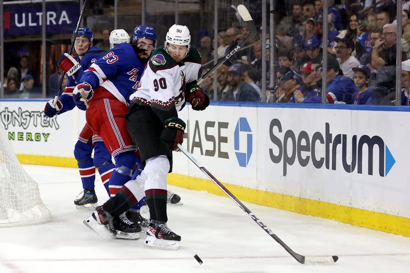 Oct 16, 2023; New York, New York, USA; New York Rangers center Mika Zibanejad (93) and Arizona Coyotes defenseman J.J. Moser (90) fight for the puck during the second period at Madison Square Garden. Mandatory Credit: Brad Penner-USA TODAY Sports