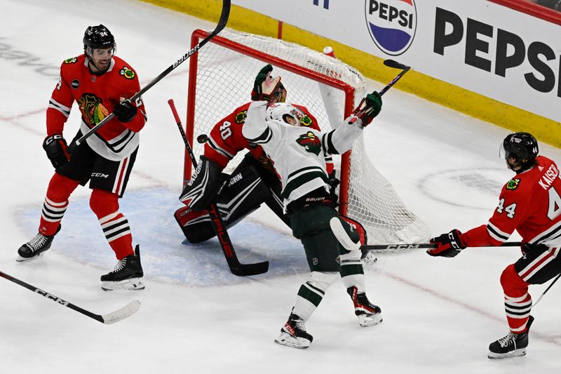 Apr 7, 2024; Chicago, Illinois, USA;  Chicago Blackhawks goaltender Arvid Soderblom (40) and Minnesota Wild right wing Mats Zuccarello (36) watch the puck during the first period at the United Center. Mandatory Credit: Matt Marton-USA TODAY Sports